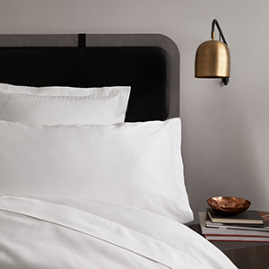 H by FretteSheets, Pillow Shams, and Duvet Cover in white percale on bed